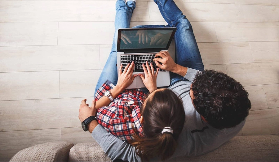couple-on-floor-laptop-compressed couple on floor with laptop